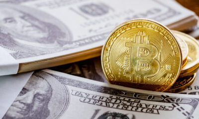 US Dollar and Bitcoin placed together to show investment concept