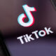 An image of the TikTok logo on a phone screen