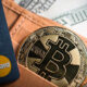 Debit cards, Bitcoin and dollar bills